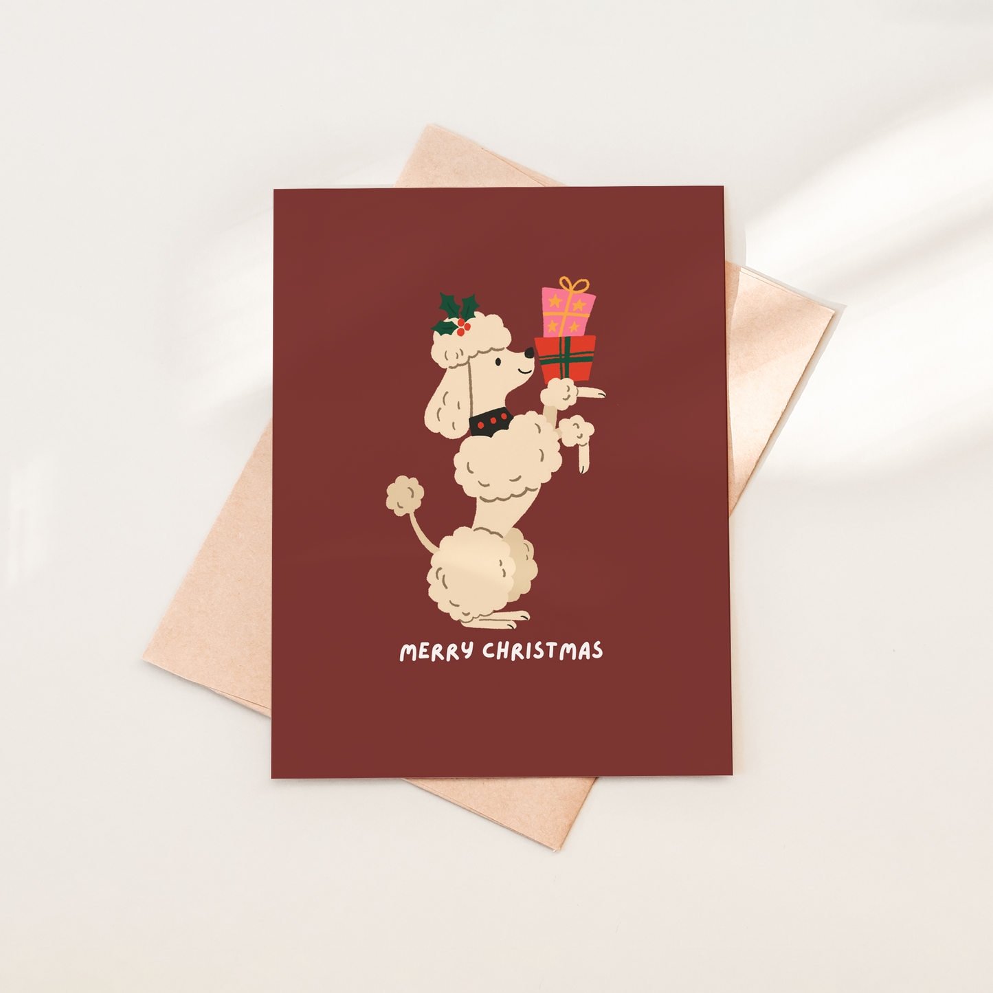 Christmas card with a dog illustration and 'Merry Christmas' text on a red background.