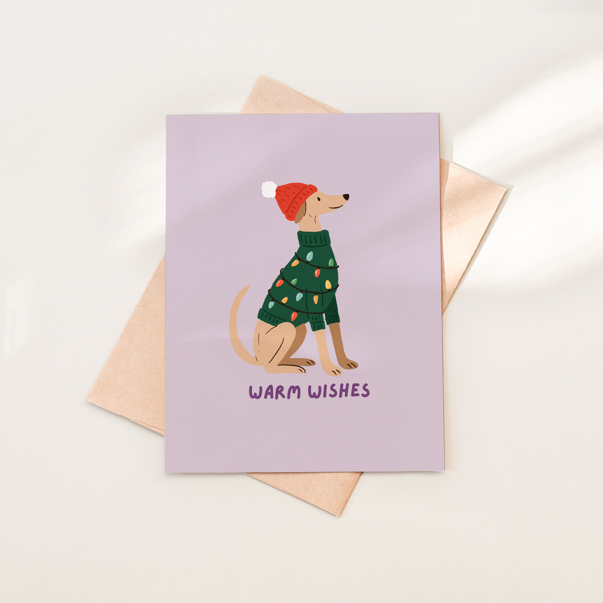 Greeting card with a dog illustration and 'Warm Wishes' text on a light purple background.